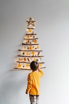 child decorating a xmas tree